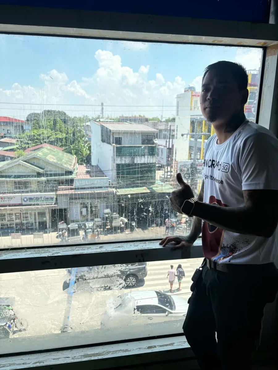 Tristan in his Honor 5G shirt overlooking Apalit town
